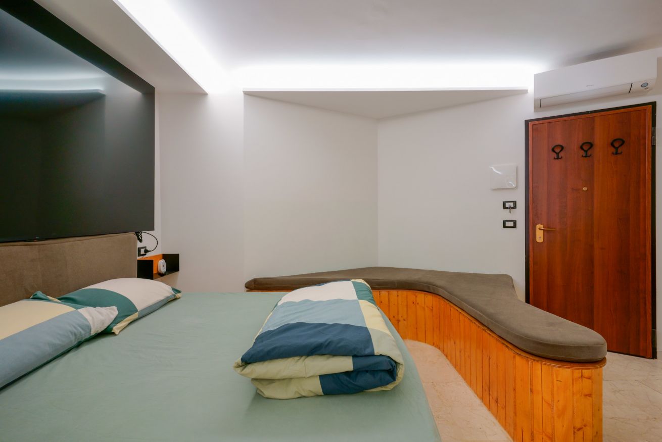 Camera accogliente con letto matrimoniale, arredi in legno naturale e spazi generosi, perfetta per un soggiorno confortevole e rilassante.